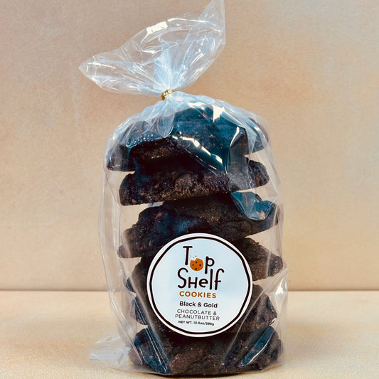 Packaged cookies labeled 'Top Shelf Cookies' with 'Black & Gold' on the label, indicating a dark color theme consistent with the product's name.
