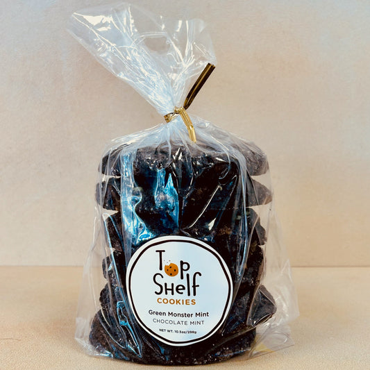 Packaged cookies labeled as Green Monster Mint from Top Shelf Cookies, visible through a clear plastic bag.