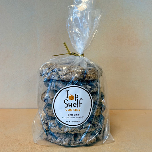 Bag of blueberry ginger cookies with 'Top Shelf Cookies' label on a plain background