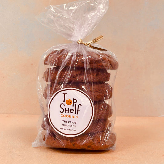 Packaged molasses cookies with the brand 'Top Shelf Cookies' visible on the label.